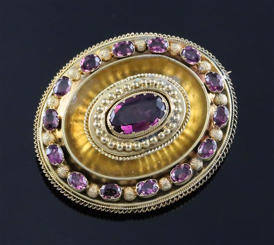 A Victorian gold (tests as 15ct) and garnet set oval pendant brooch, gross 11.4 grams.